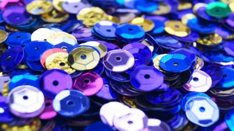 Photo of Many different colorful sequins as background, closeup