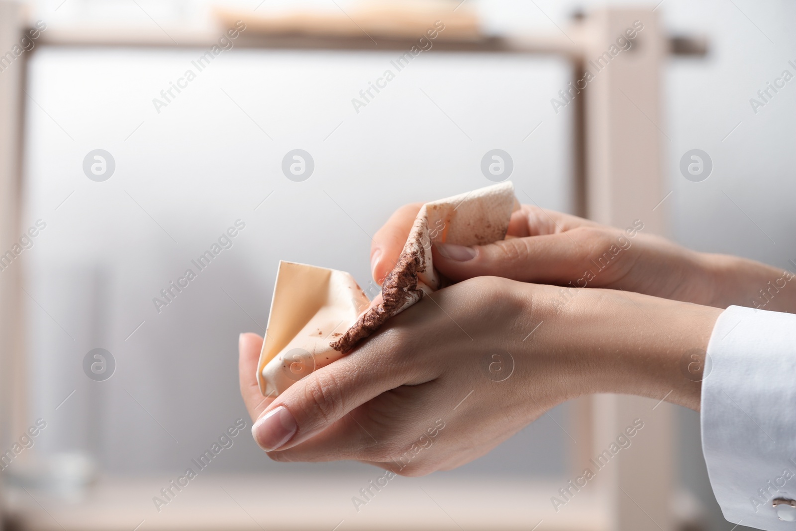 Photo of Woman cleaning hands with paper napkin indoors, closeup