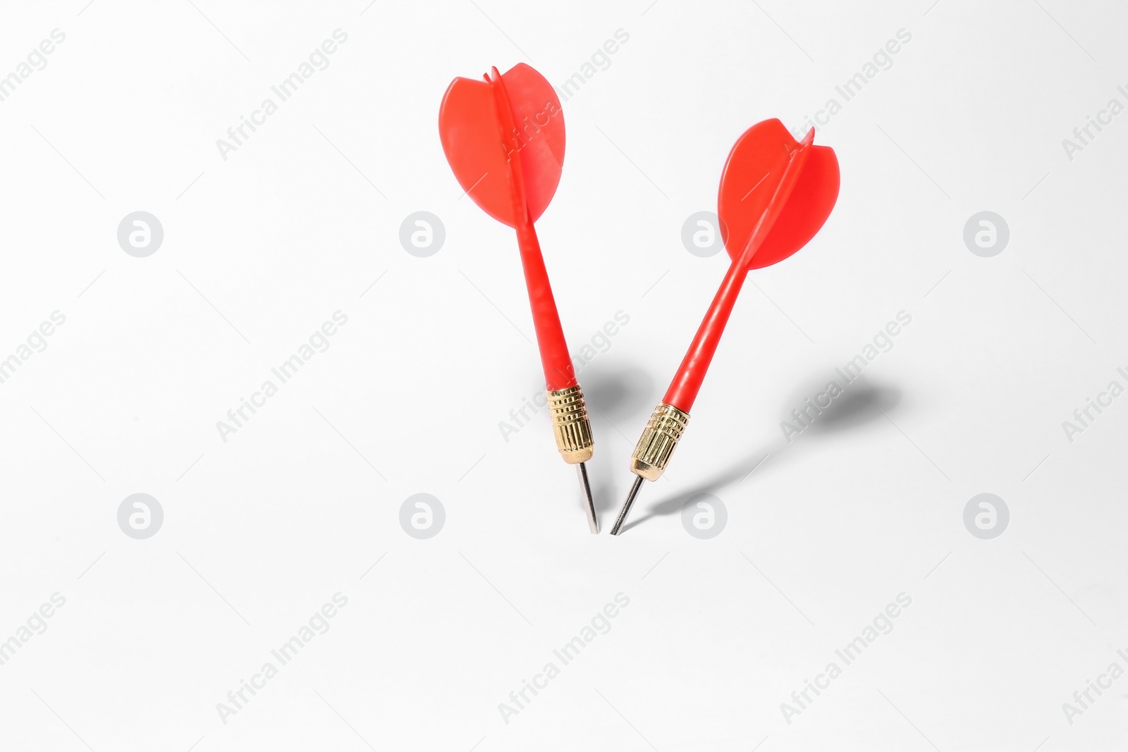 Photo of Red dart arrows for game on white background