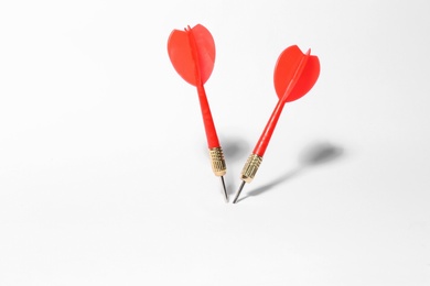 Photo of Red dart arrows for game on white background