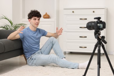 Photo of Teenage blogger explaining something while streaming at home