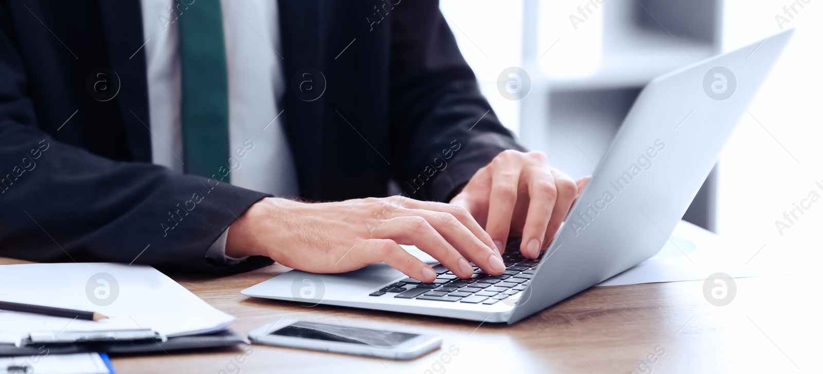 Image of Man working on computer at table in office, closeup. Banner design