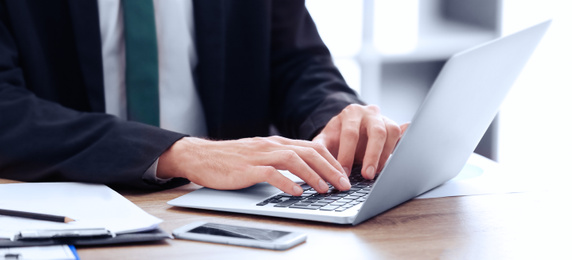 Image of Man working on computer at table in office, closeup. Banner design