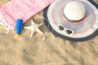 Composition with beach accessories on sand. Space for text