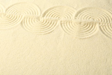 Photo of Zen rock garden. Wave pattern on beige sand