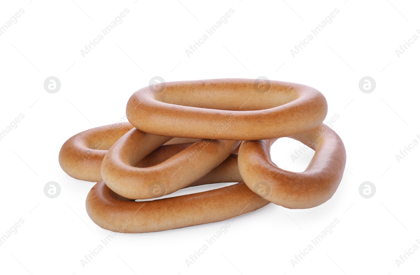 Photo of Many tasty dry bagels (sushki) isolated on white