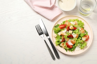 Photo of Delicious fresh Caesar salad on white wooden table, flat lay. Space for text