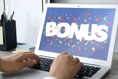 Bonus gaining. Woman using laptop at table, closeup. Illustration of falling confetti and word on device screen