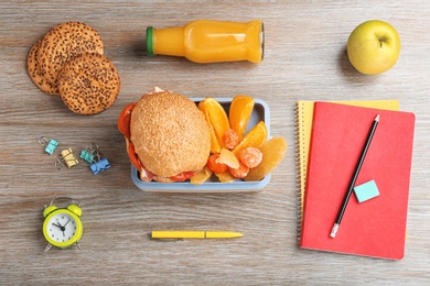 Flat lay composition with lunch box and food on wooden table