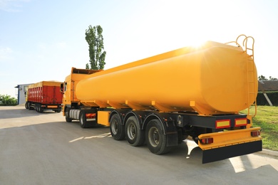 Photo of Modern bright trucks parked on country road