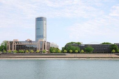 Photo of Picturesque view of modern city architecture near river