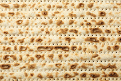 Photo of Traditional Matzo as background, top view. Pesach (Passover) celebration