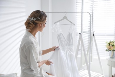 Photo of Young woman with beautiful wedding dress indoors