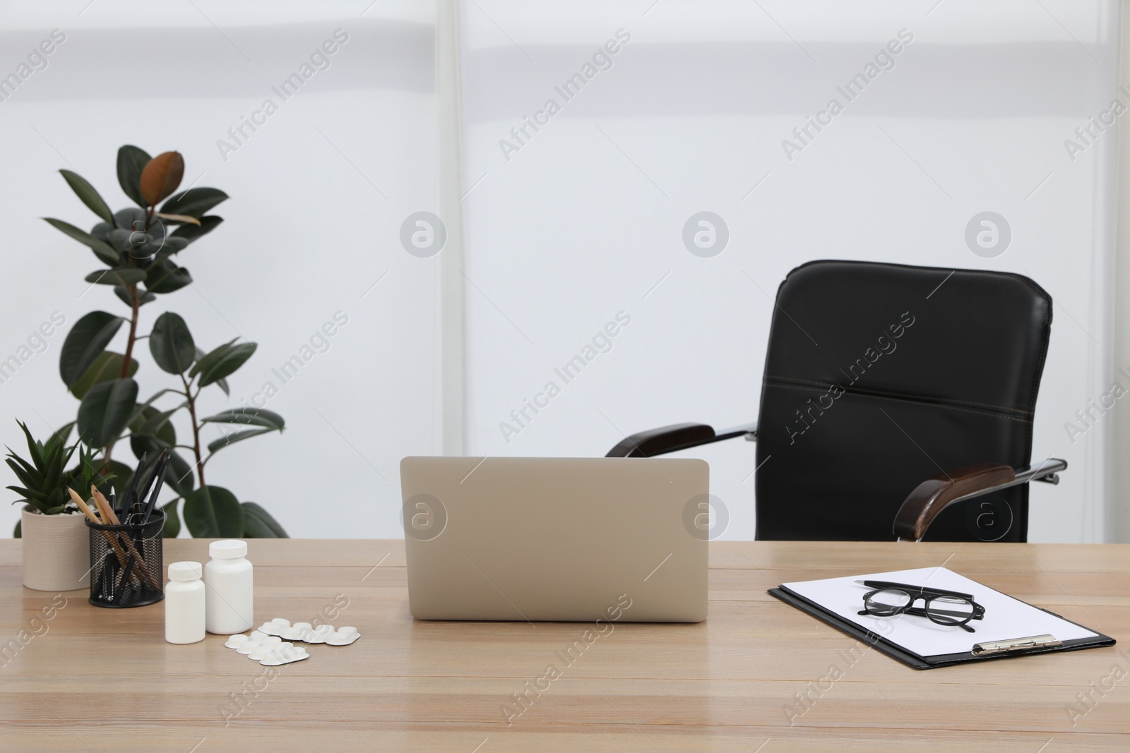 Photo of Modern doctor's workplace in office. Interior design