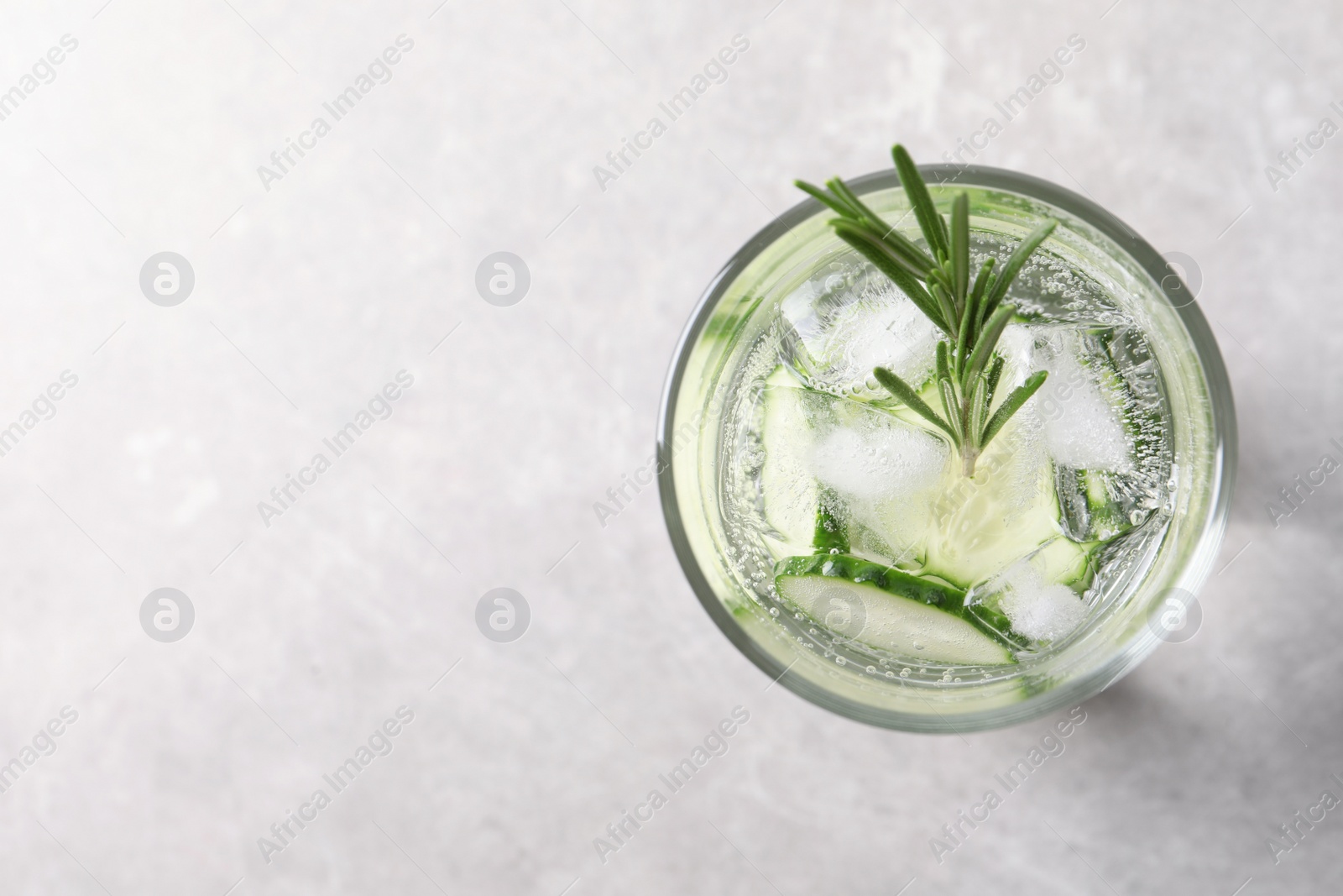 Photo of Glass of fresh cucumber water on grey background, top view. Space for text