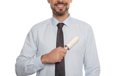 Man cleaning shirt with adhesive lint roller on white background, closeup