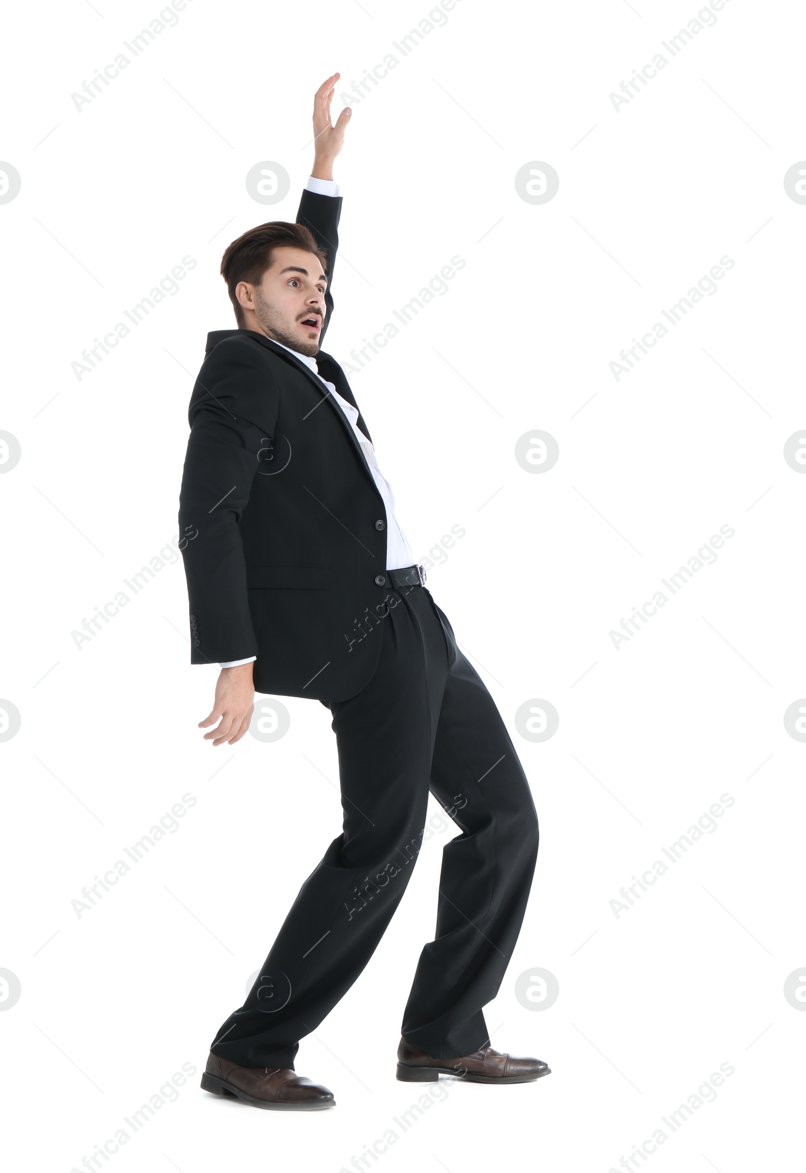 Photo of Young businessman attracted to magnet on white background