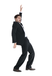 Young businessman attracted to magnet on white background