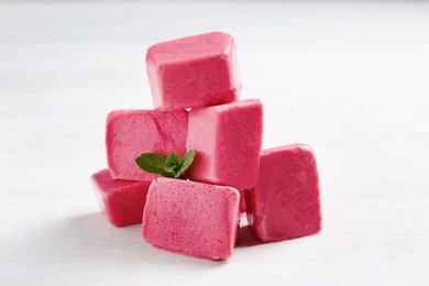 Tasty berry ice cubes on light table