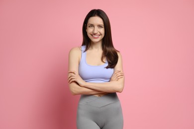 Photo of Happy young woman with slim body on pink background