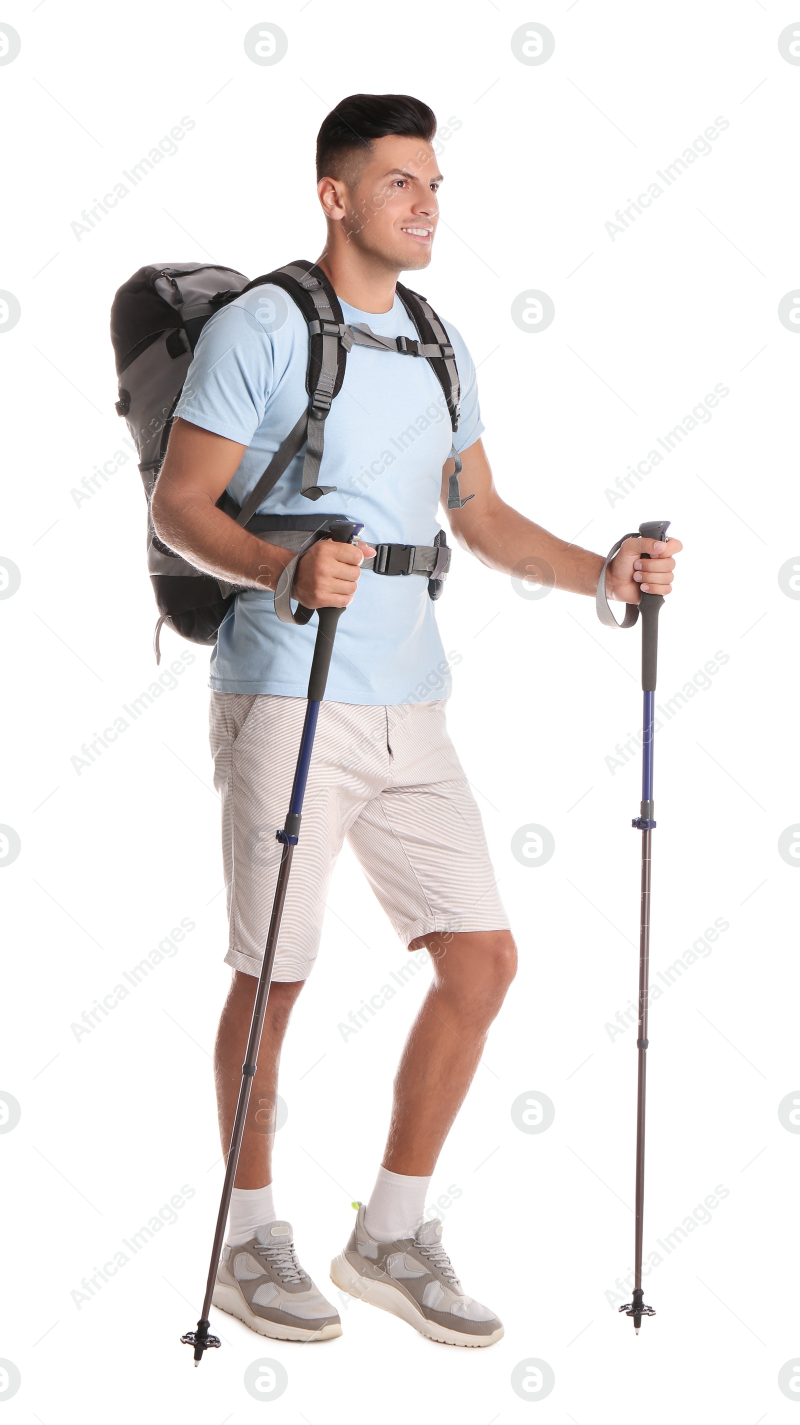 Photo of Male hiker with backpack and trekking poles on white background