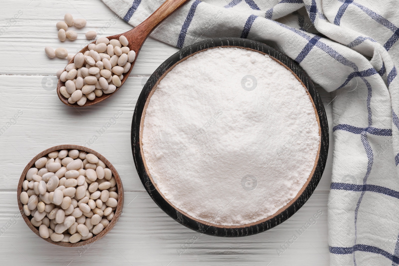 Photo of Kidney bean flour and seeds on white wooden table, flat lay