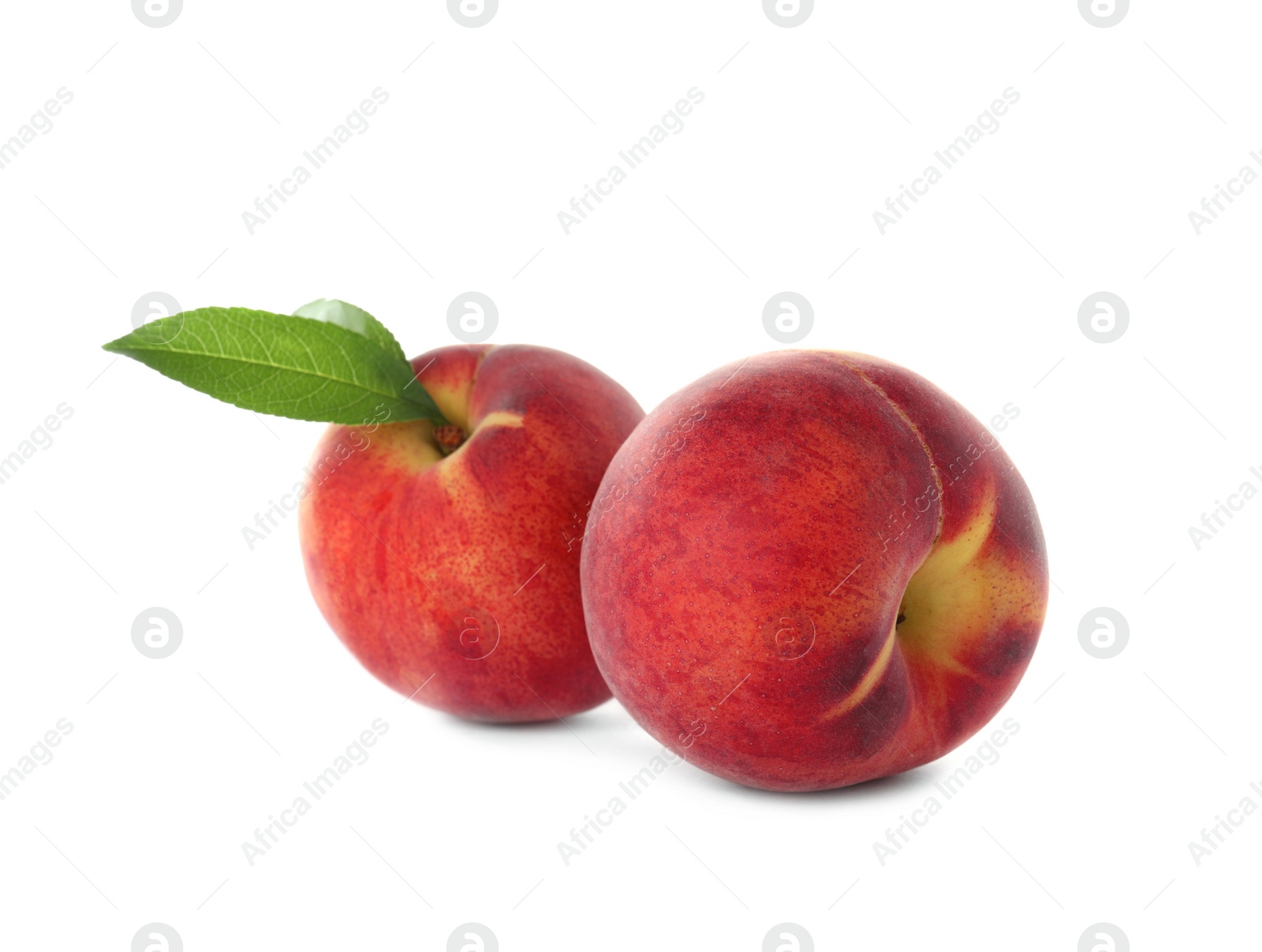 Photo of Delicious ripe peaches with leaf isolated on white