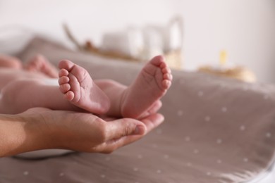 Mother and her little baby on bed, closeup