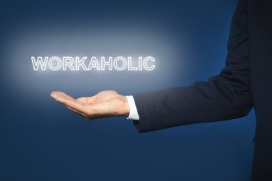 Image of Businessman and word Workaholic on blue background, closeup