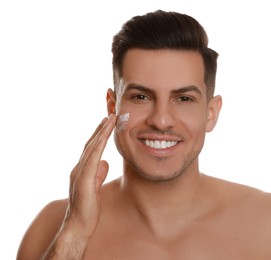 Photo of Handsome man applying face cream on white background