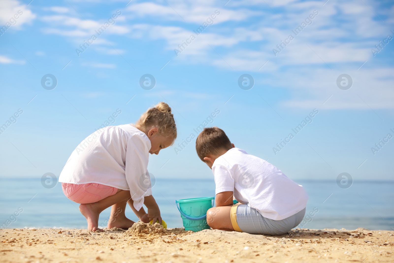 Photo of Little children playing on sea beach outside