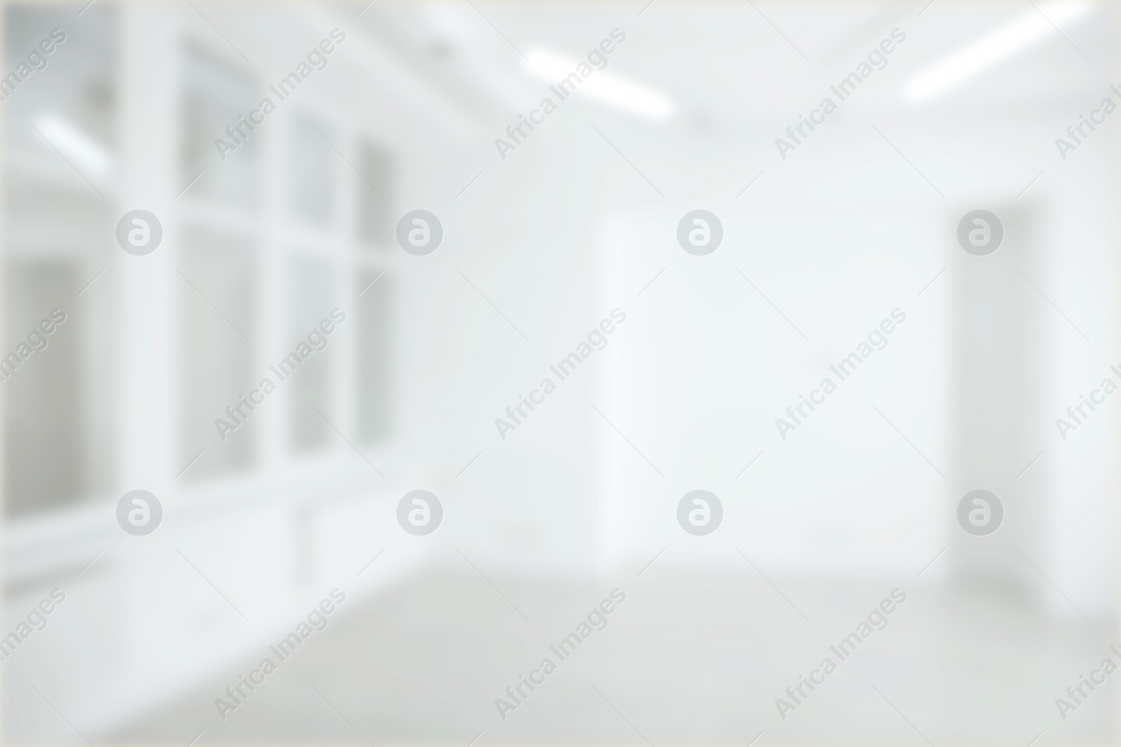 Image of Empty room with white walls and large window, blurred view