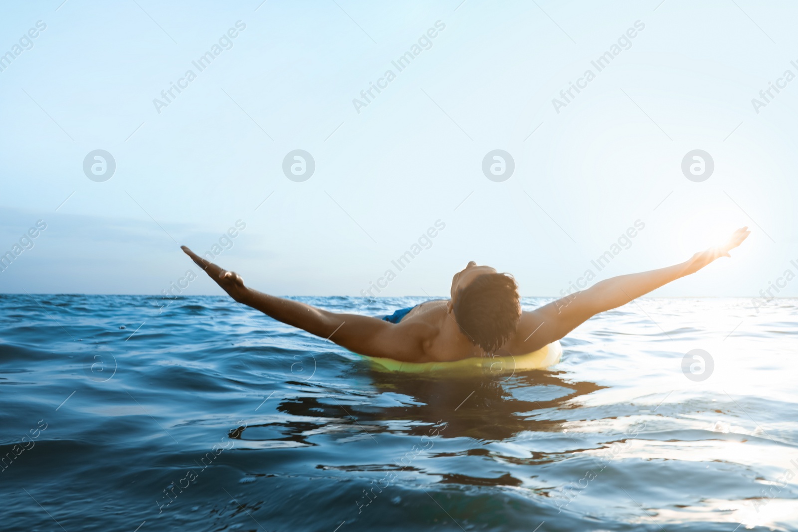 Photo of Young man with inflatable ring in sea