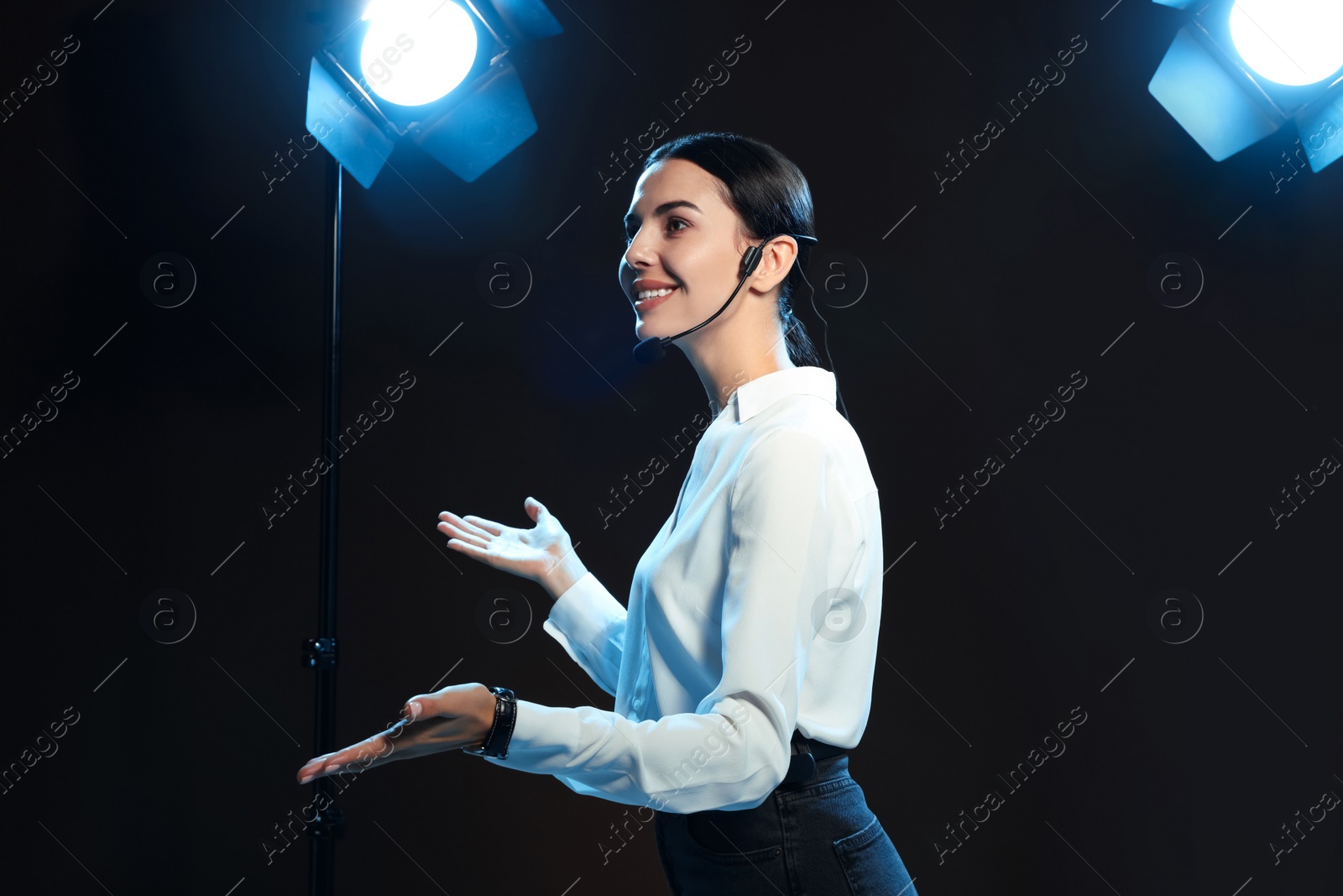 Photo of Motivational speaker with headset performing on stage