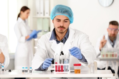 Male scientist working at table in laboratory. Research and analysis