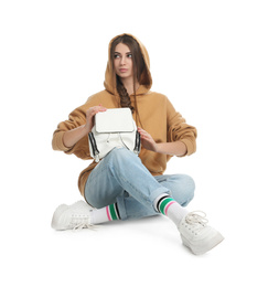 Beautiful young woman in casual outfit with stylish bag on white background