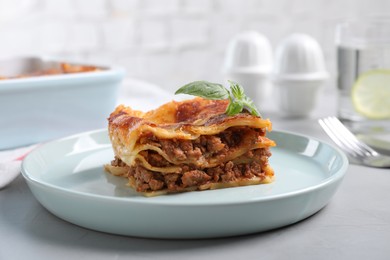 Tasty cooked lasagna served on grey table