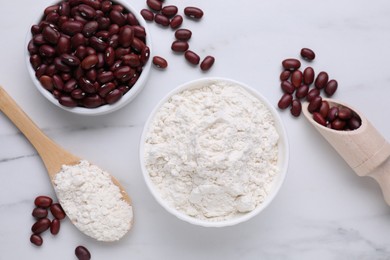 Kidney bean flour and seeds on white marble table, flat lay