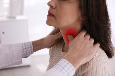 Image of Endocrine system. Doctor examining patient's thyroid gland in hospital, closeup