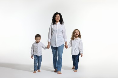 Little children with their mother on white background