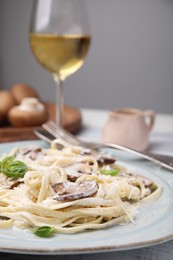 Photo of Delicious pasta with mushrooms and cheese on table, closeup
