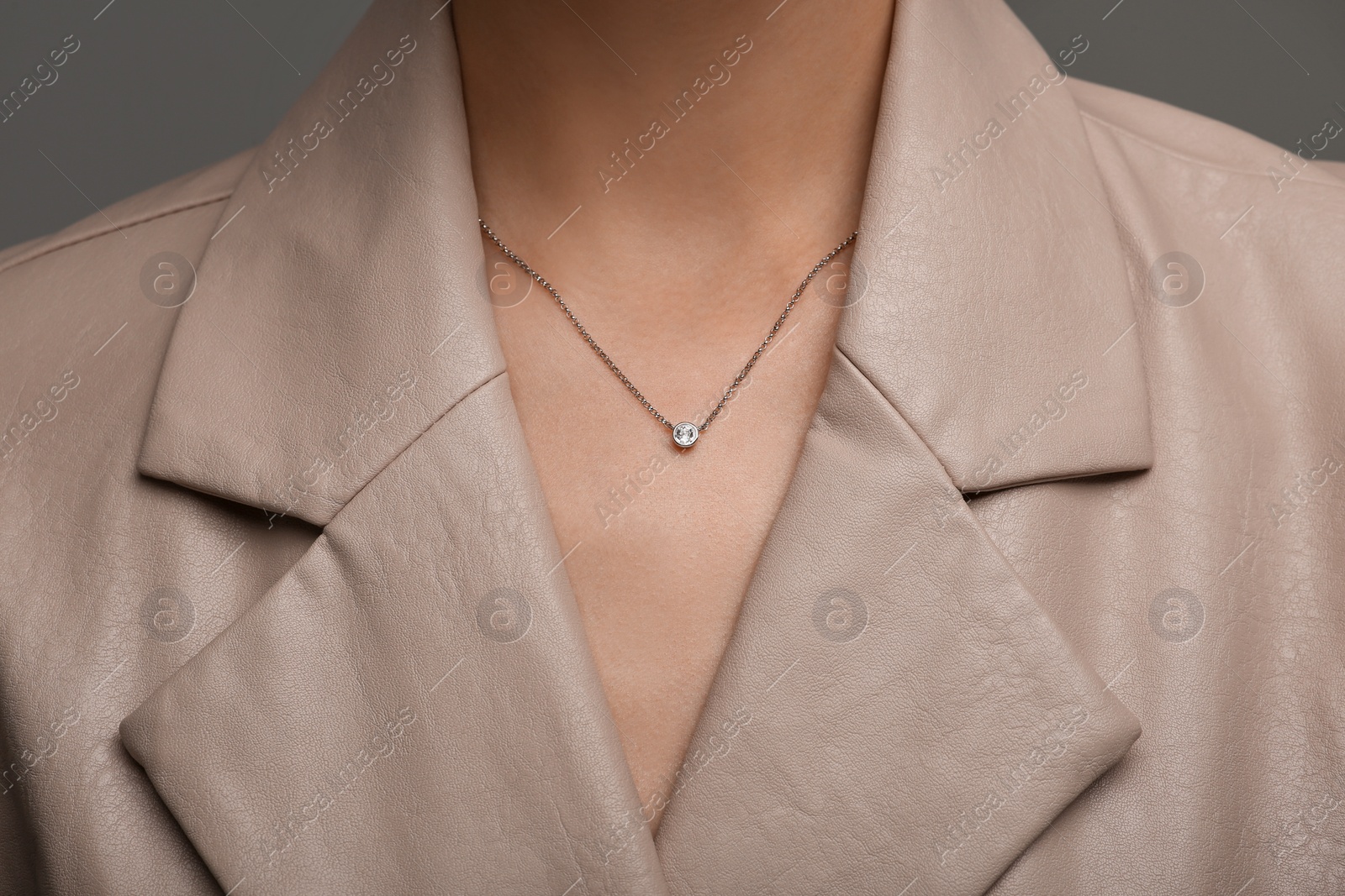 Photo of Woman with elegant necklace on dark grey background, closeup