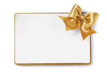 Photo of Blank gift card with golden bow isolated on white, top view