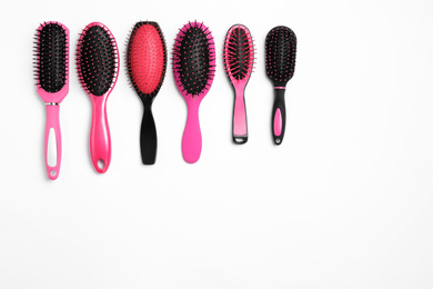 Composition with hair brushes on white background, top view