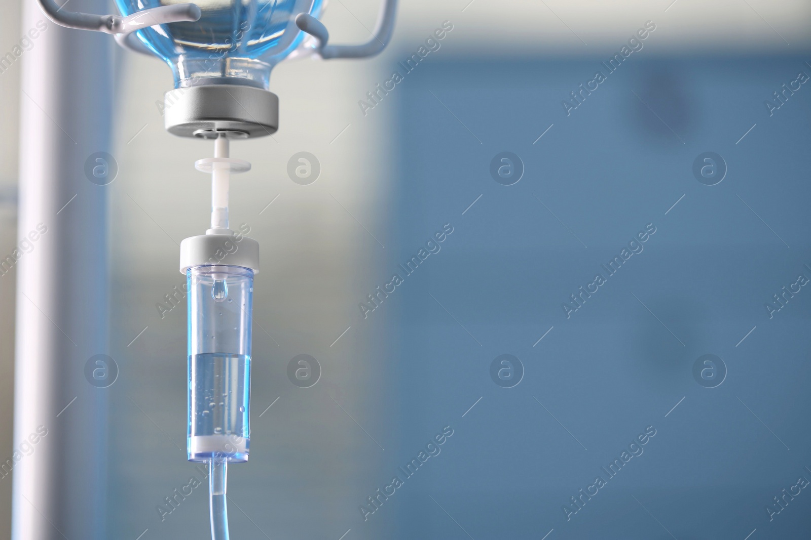 Photo of IV drip against blurred background, space for text