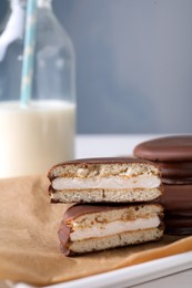 Photo of Tasty choco pies on parchment paper. Snack cakes