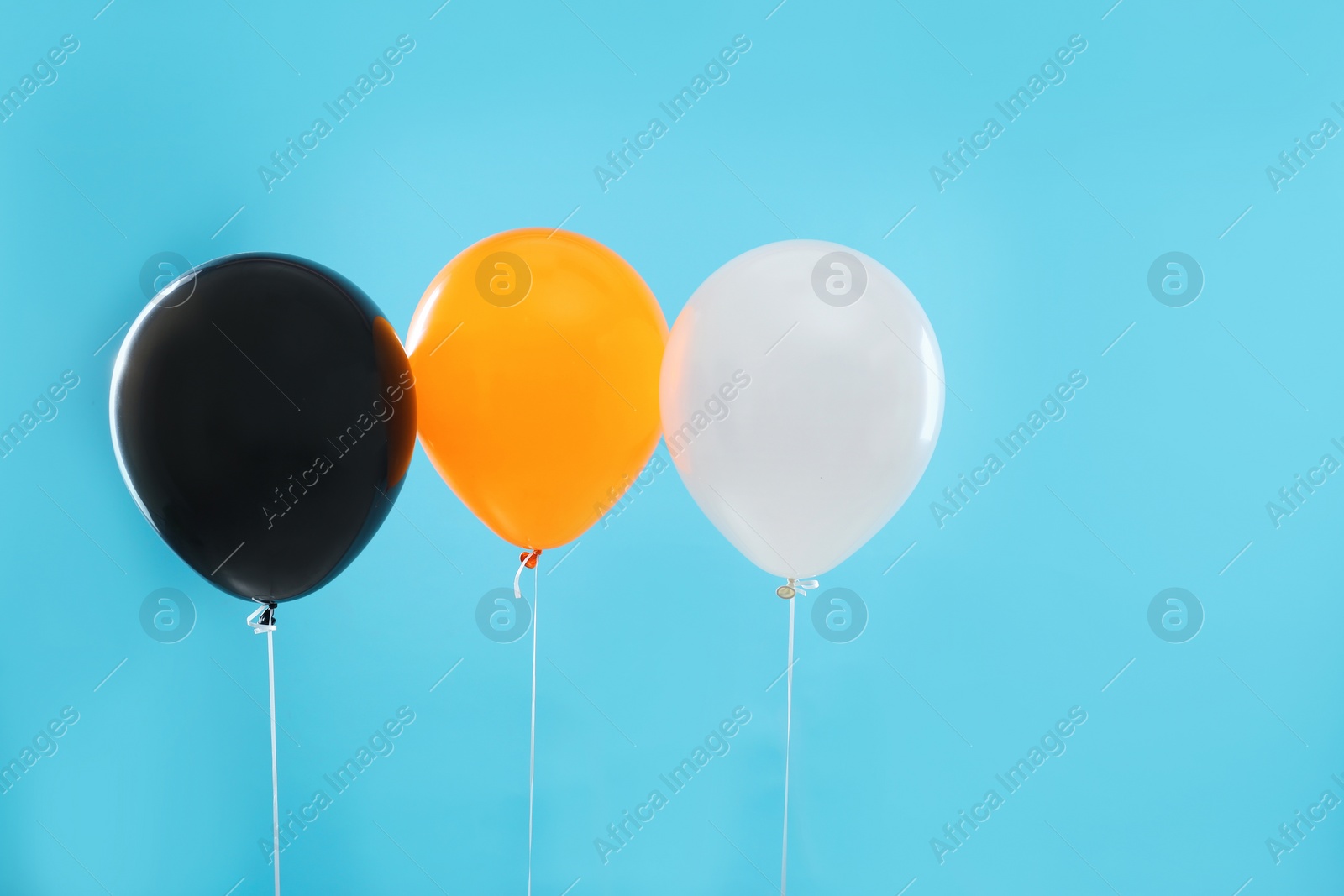 Photo of Colorful balloons on blue background. Halloween party