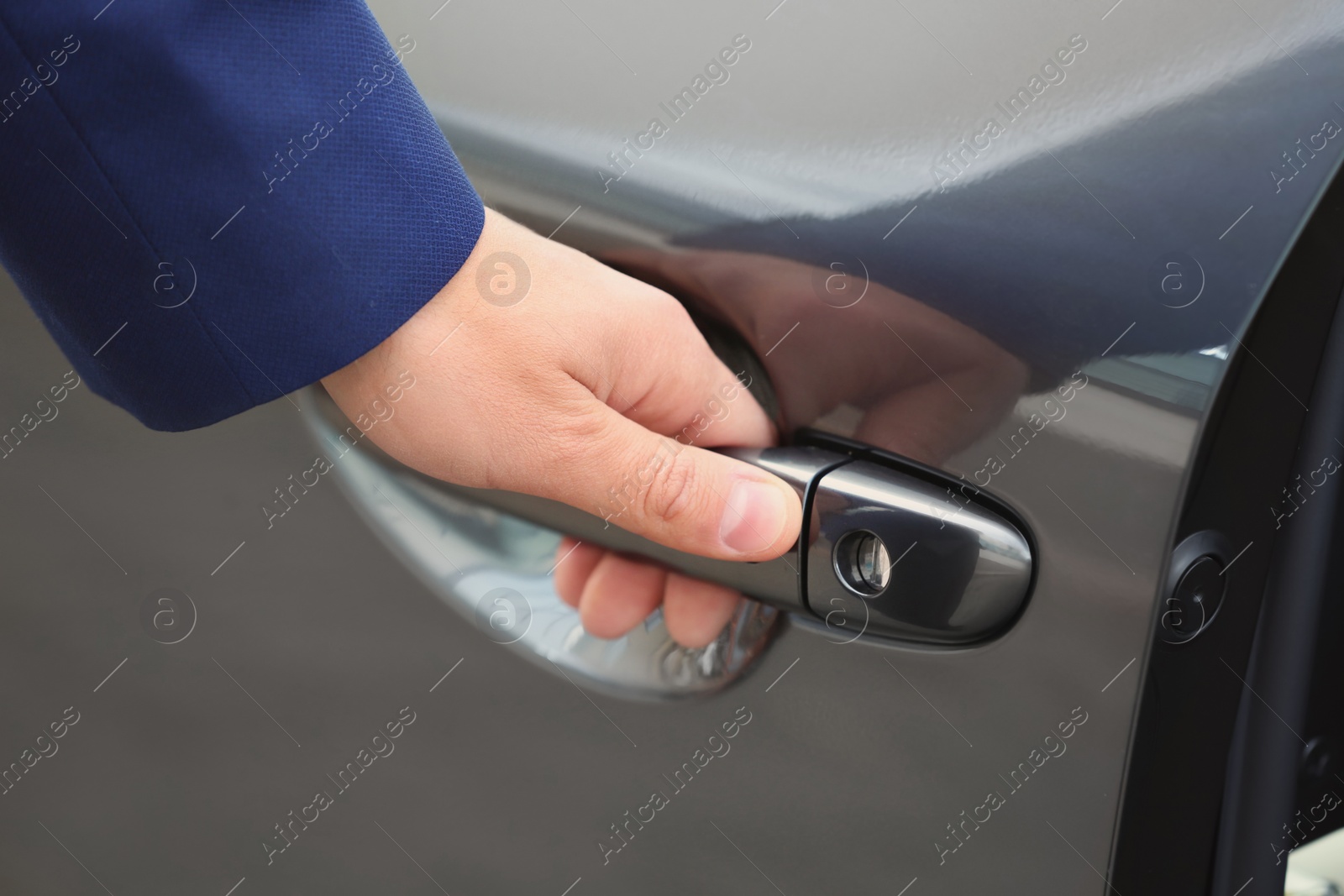 Photo of Closeup view of man opening car door