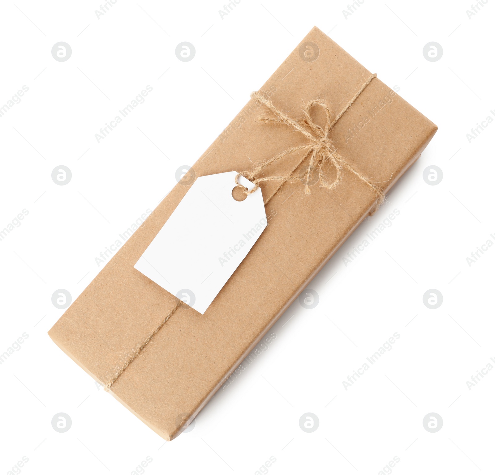 Photo of Gift box wrapped in kraft paper with bow and tag isolated on white