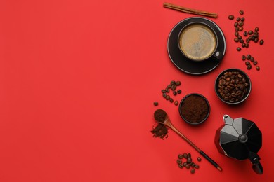 Flat lay composition with ground coffee and roasted beans on red background, space for text